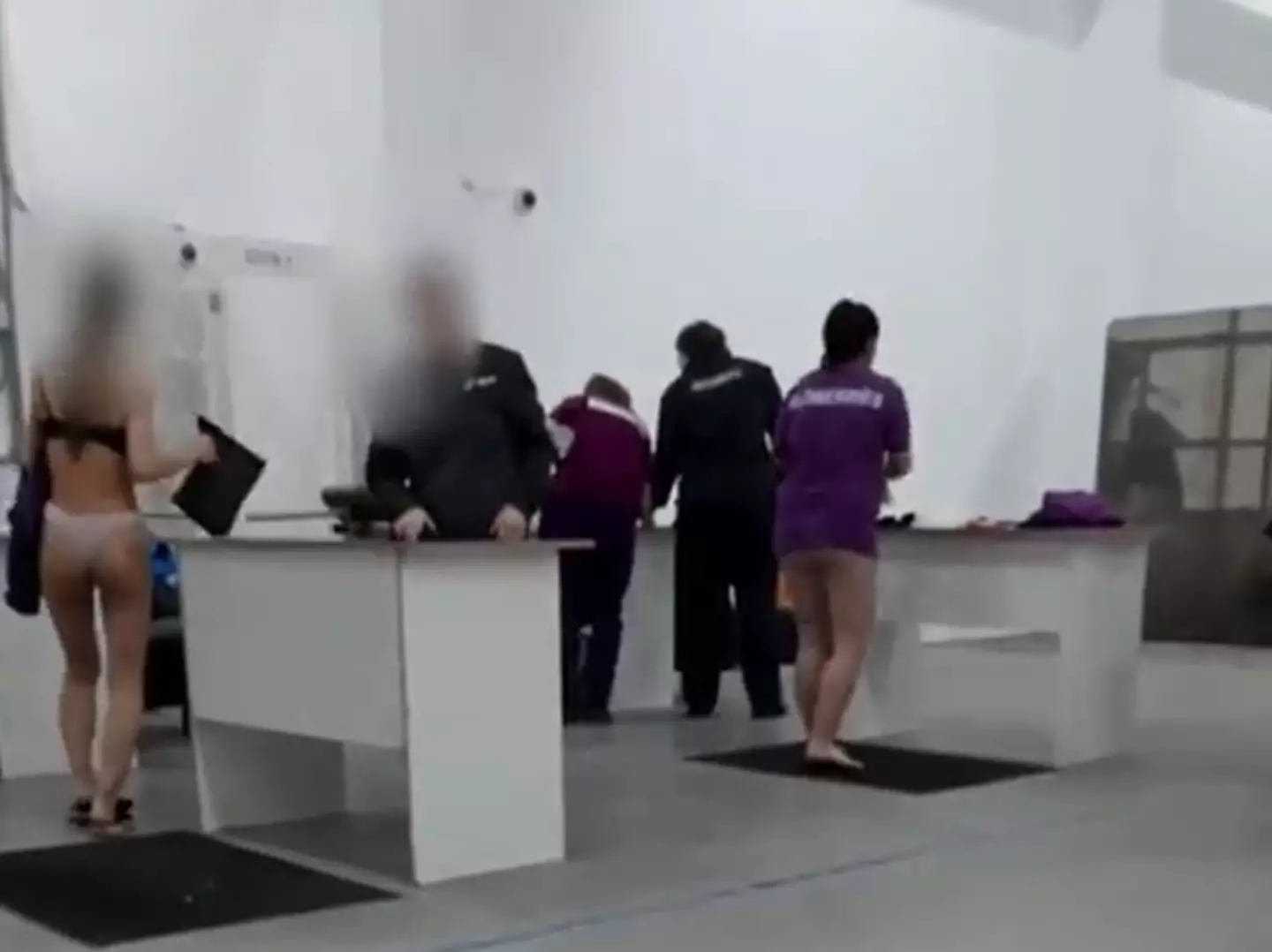 The footage showed workers in Russia being forced to go through a strip search.