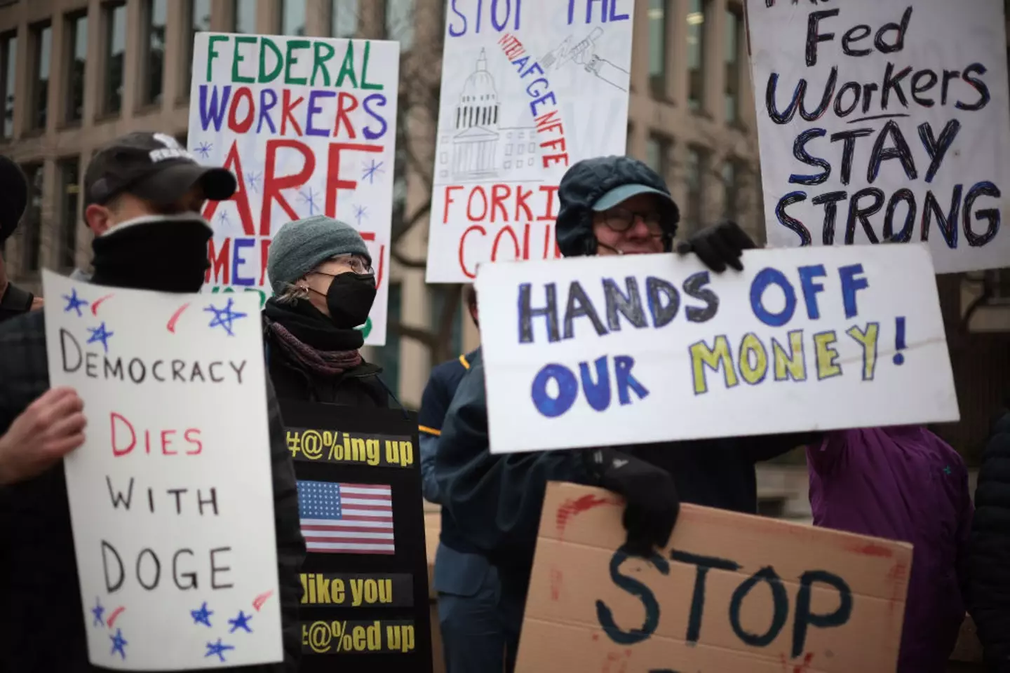 Protesters rally outside of the Theodore Roosevelt Federal Building headquarters of the US Office of Personnel Management in February (Alex Wong/Getty Images)