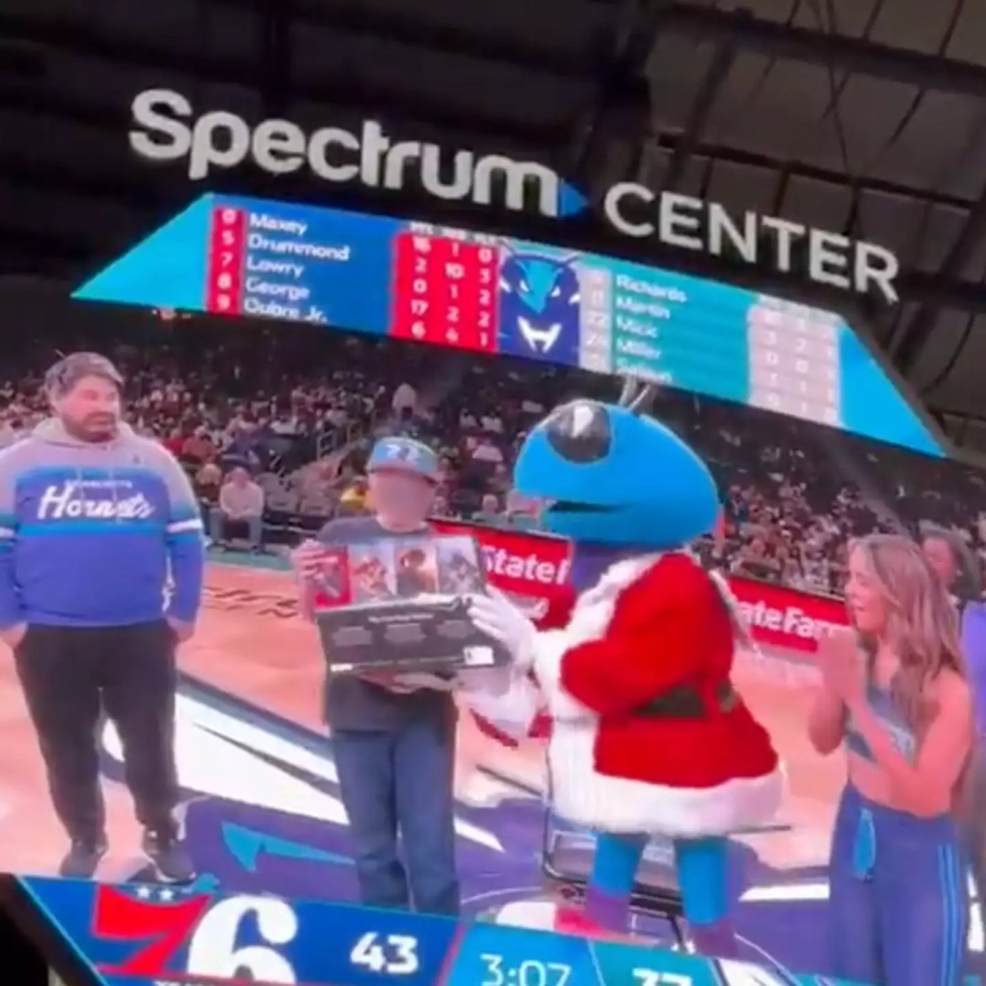 NBA side Charlotte Hornets pretended to give a child a PS5 before snatching it off him when the cameras weren't on him (X/@StanUsmnt)