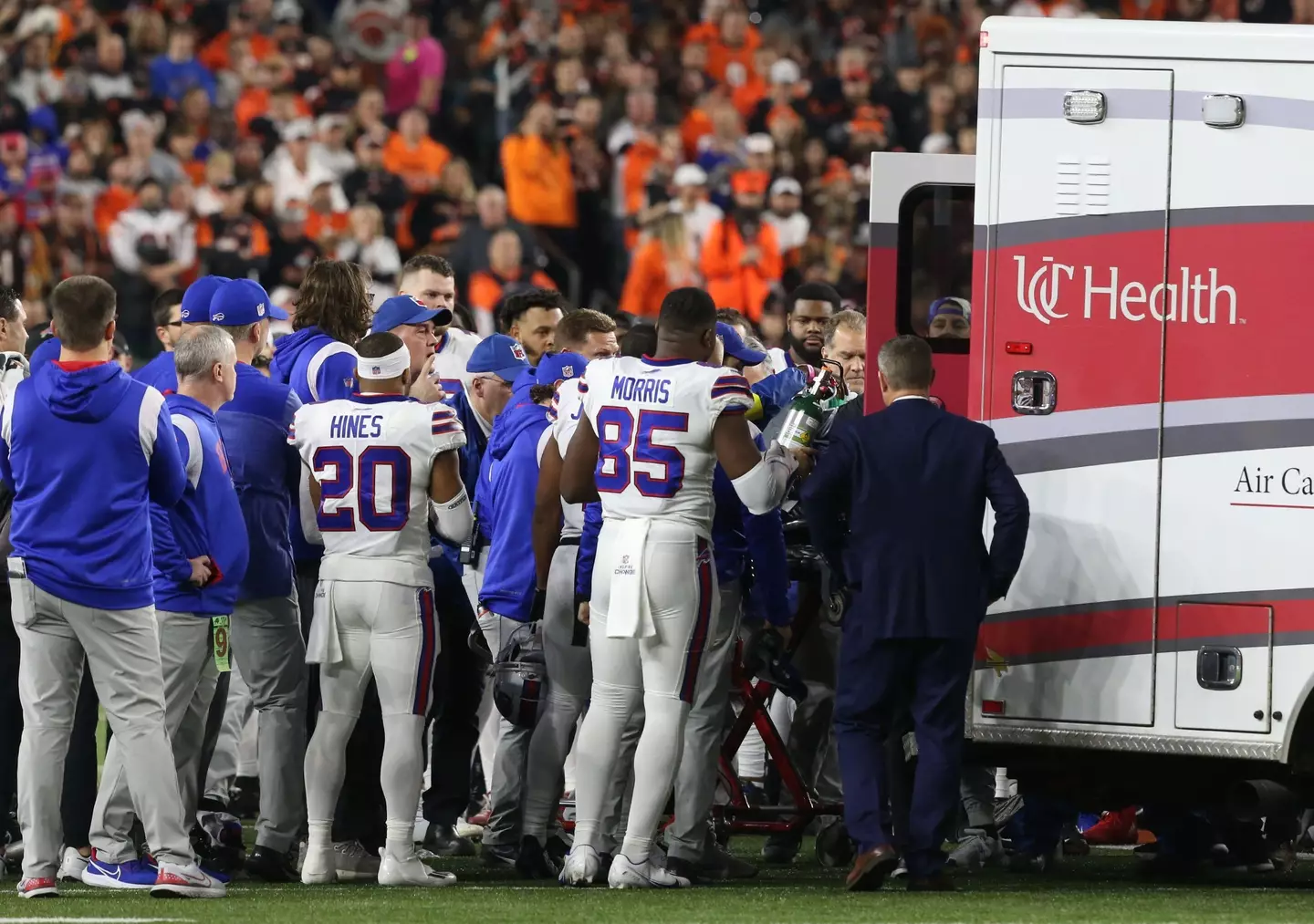 Buffalo Bills players surround their teammate as he was escorted into an ambulance.