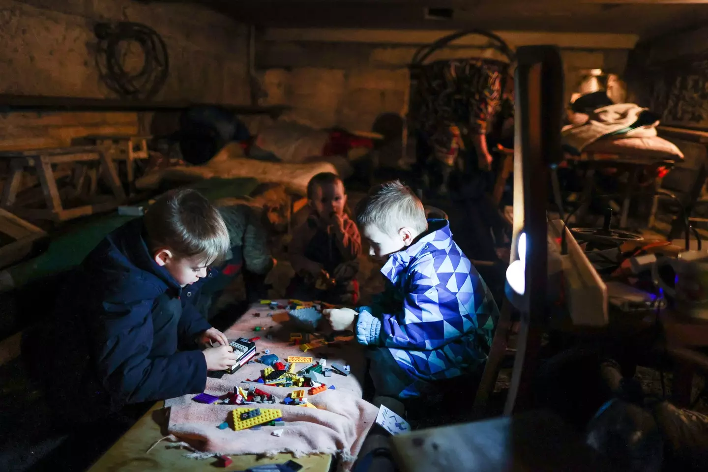 Children hide in a bomb shelter in the basement of an apartment block (Alamy)