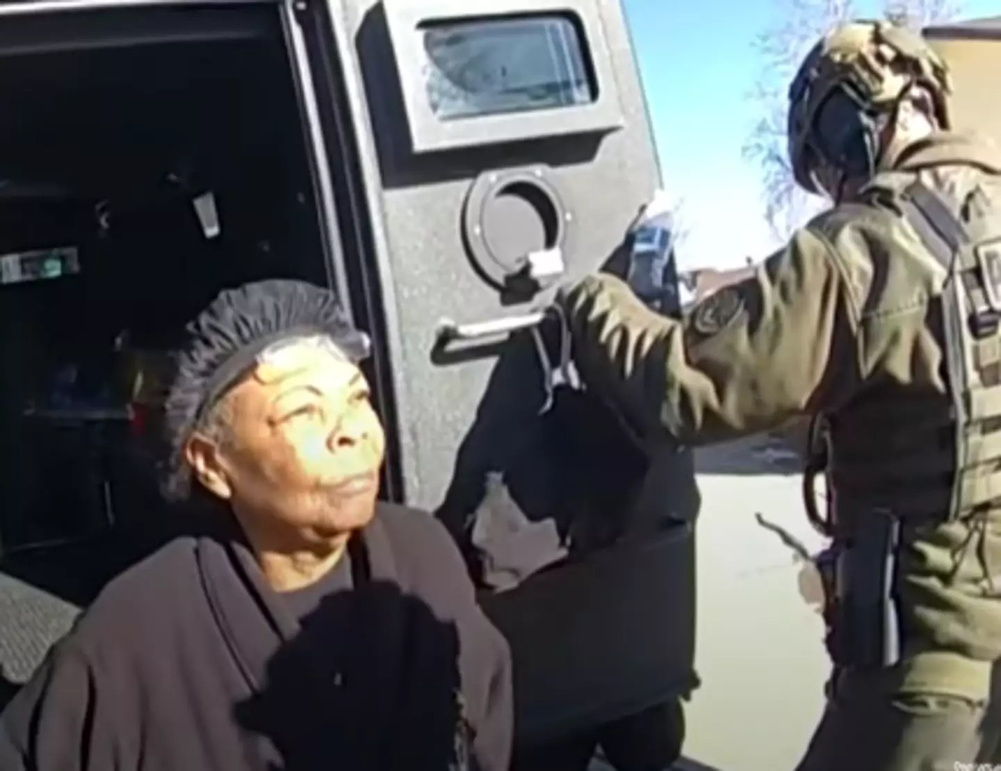 Johnson in the back of a police vehicle.