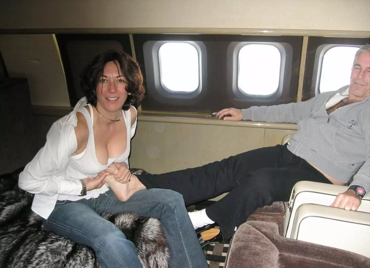 Ghislaine Maxwell rubbing Jeffrey Epstein's feet on a plane.