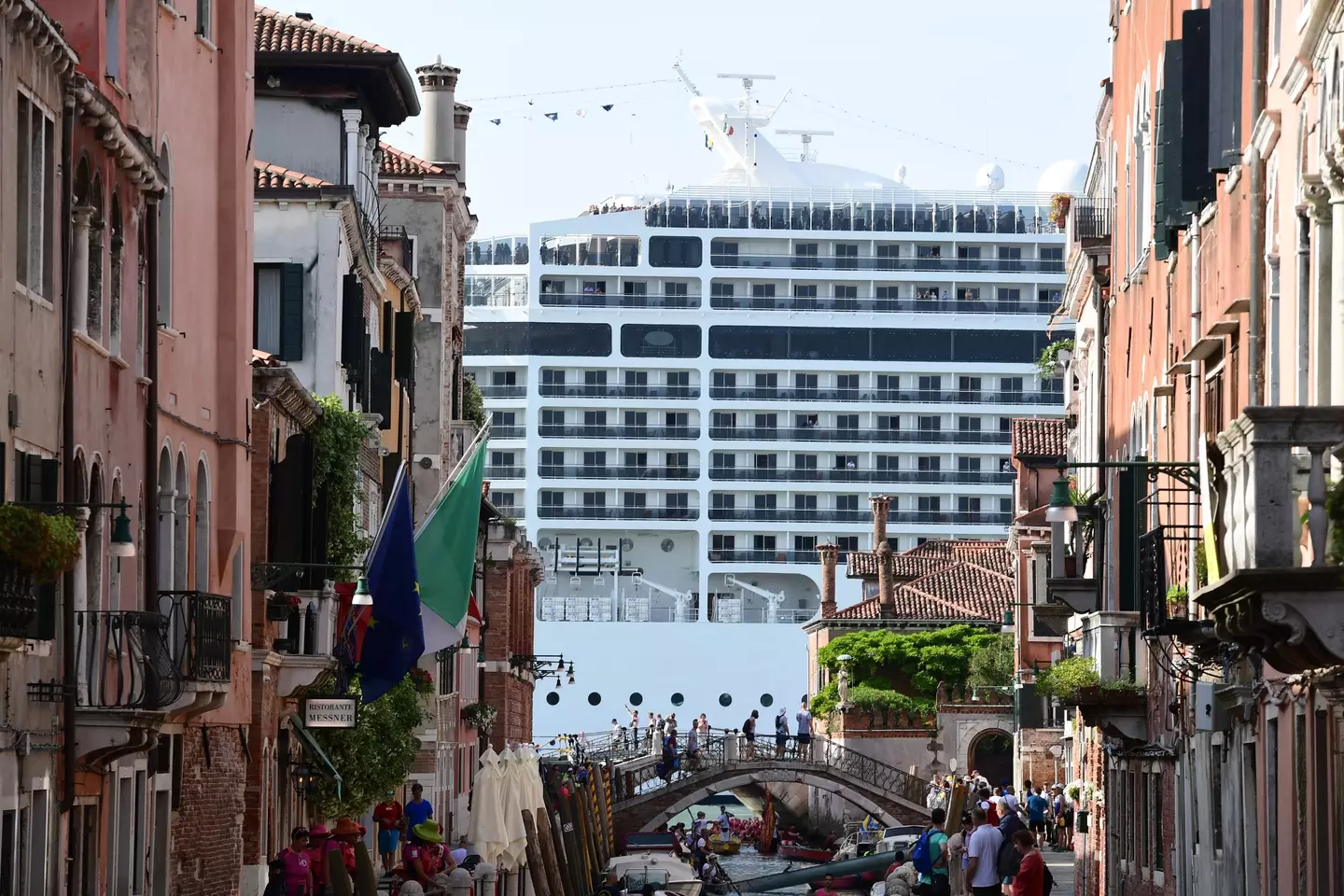 A cruise ship seen from a Venice street.