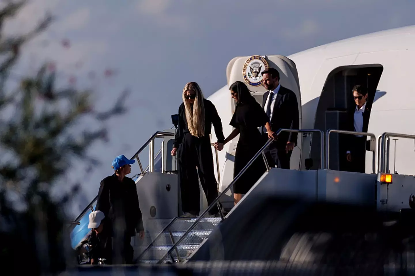 Erika Kirk seen holding Usha Vance's hand as they exit Air Force Two (Eric Thayer/Getty Images)