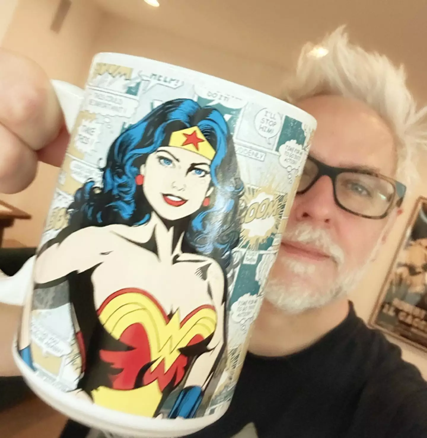 James Gunn holding a Wonder Woman mug.