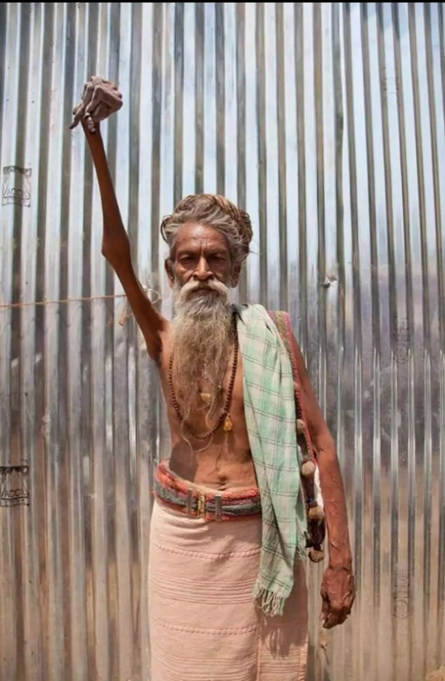 Bharati has been holding up his arm for nearly 50 years.