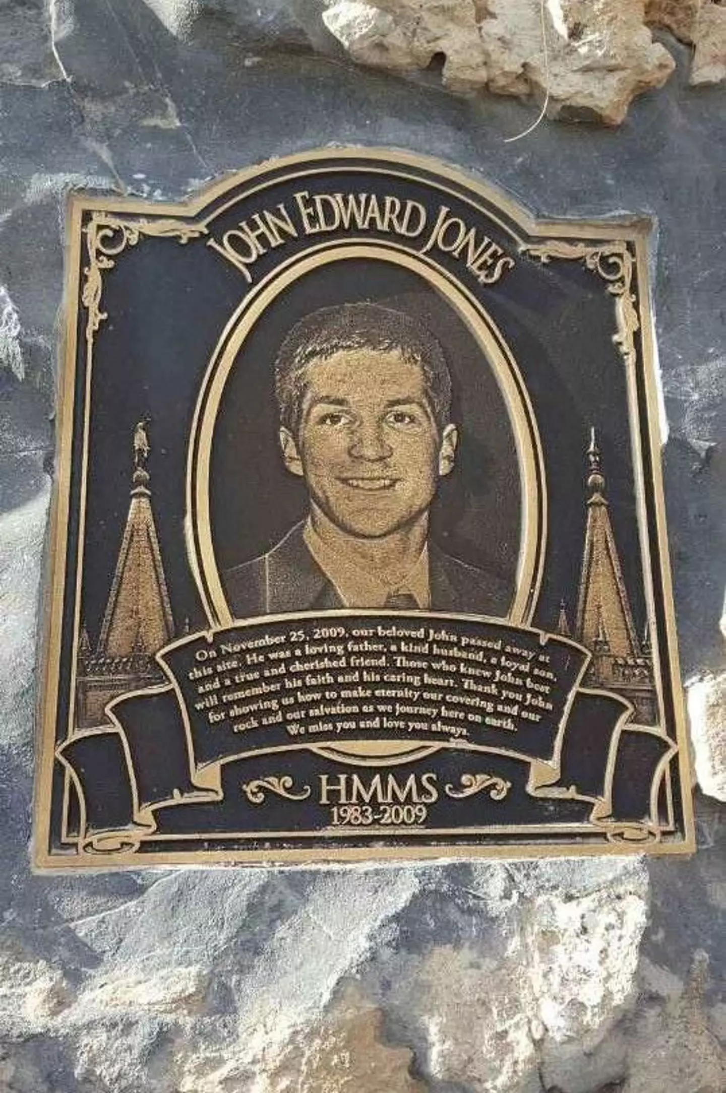 A plaque lies where the entrance to the cave used to be (Find A Grave)