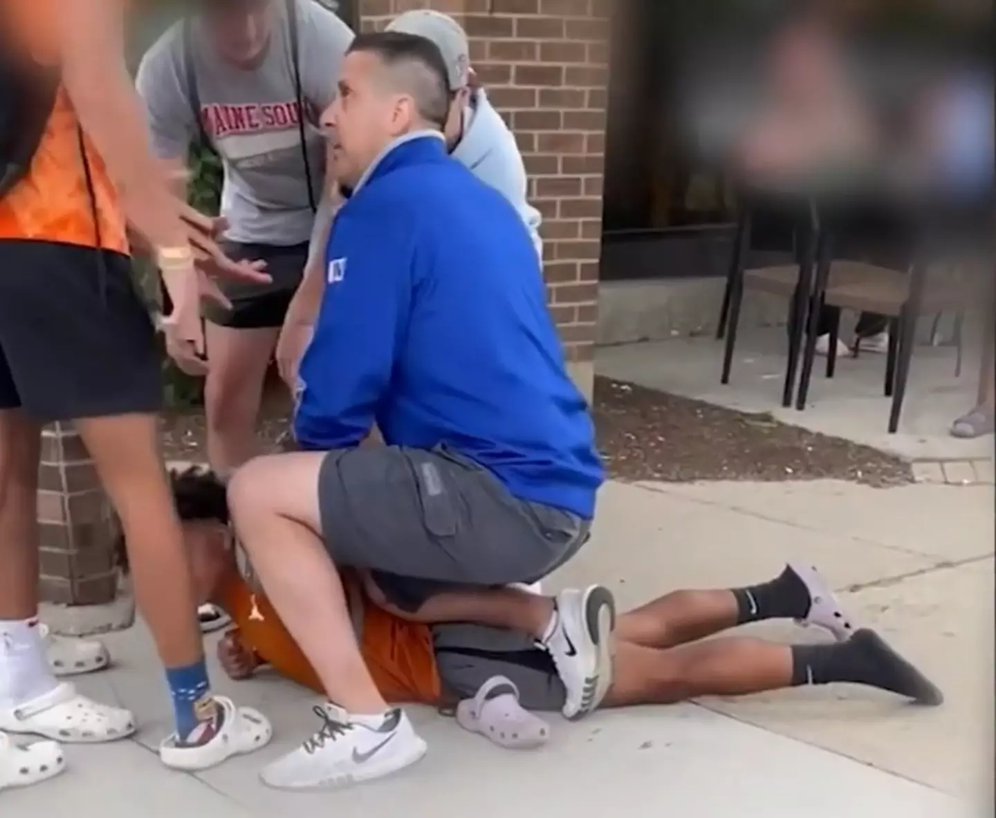 Video footage taken by the teenager's friends appears to show the off-duty police officer kneeling on the boy's back.