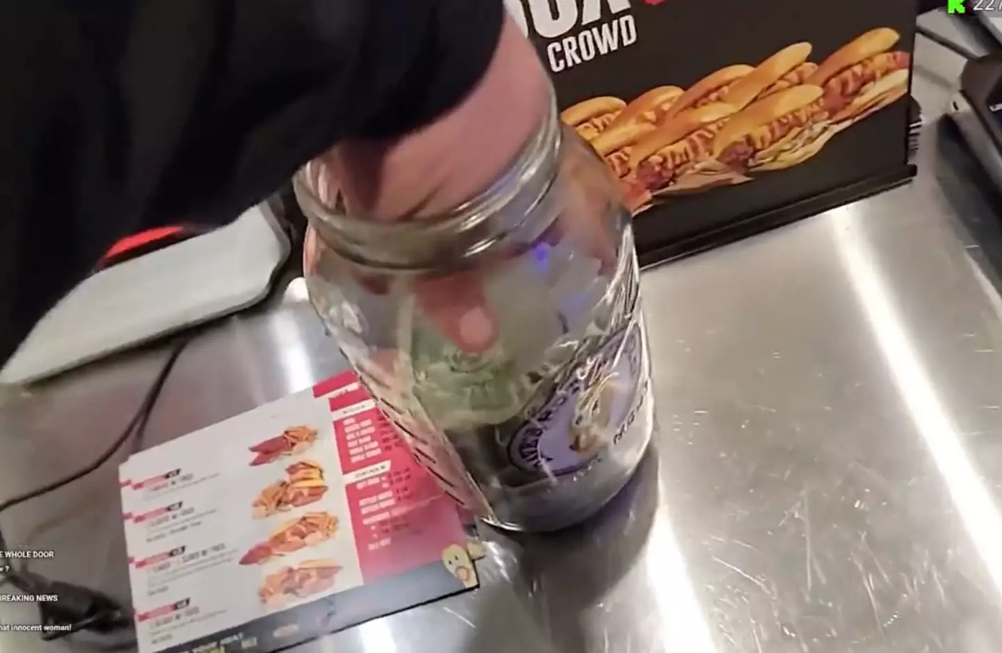 The video footage shows, in full view of his watching audience, the streamer pulled out a handful of notes from the tip jar.