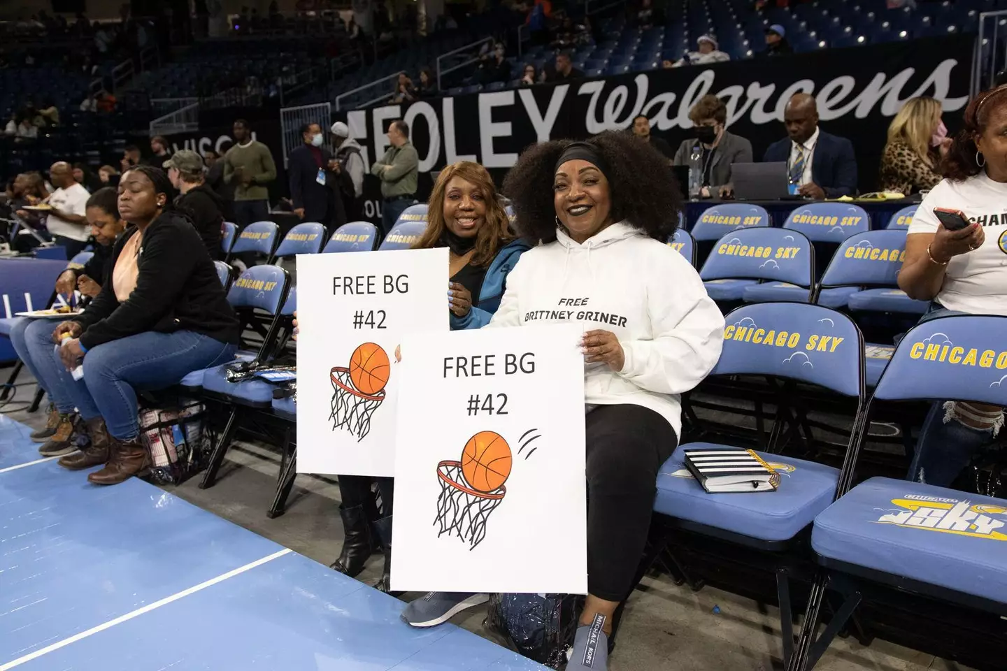 Fans hold signs in support of detained American WNBA Player Brittney Griner.