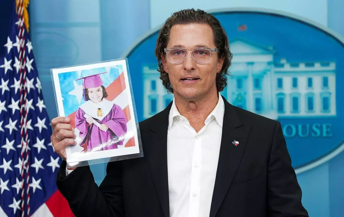 Actor Matthew McConaughey holds a picture of 10-year-old school shooting victim Alithia Ramirez.