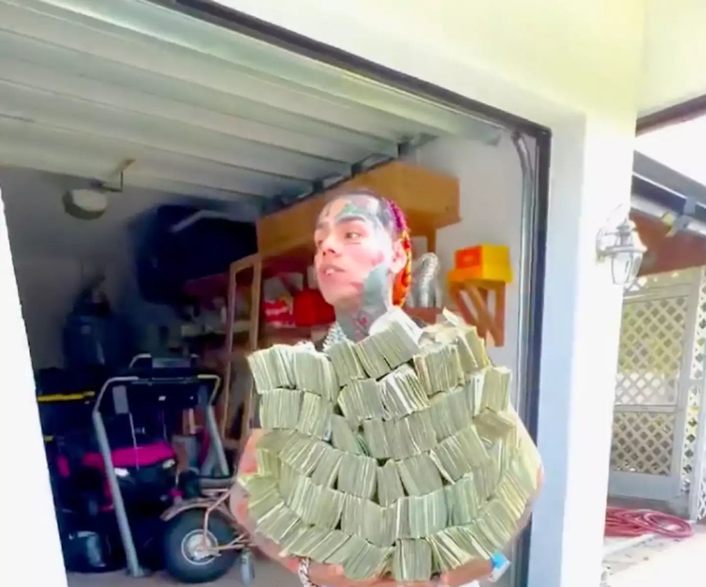 6ix9ine posts an Instagram in response to those who hate on him because of his wealth by showing them his wads of cash.