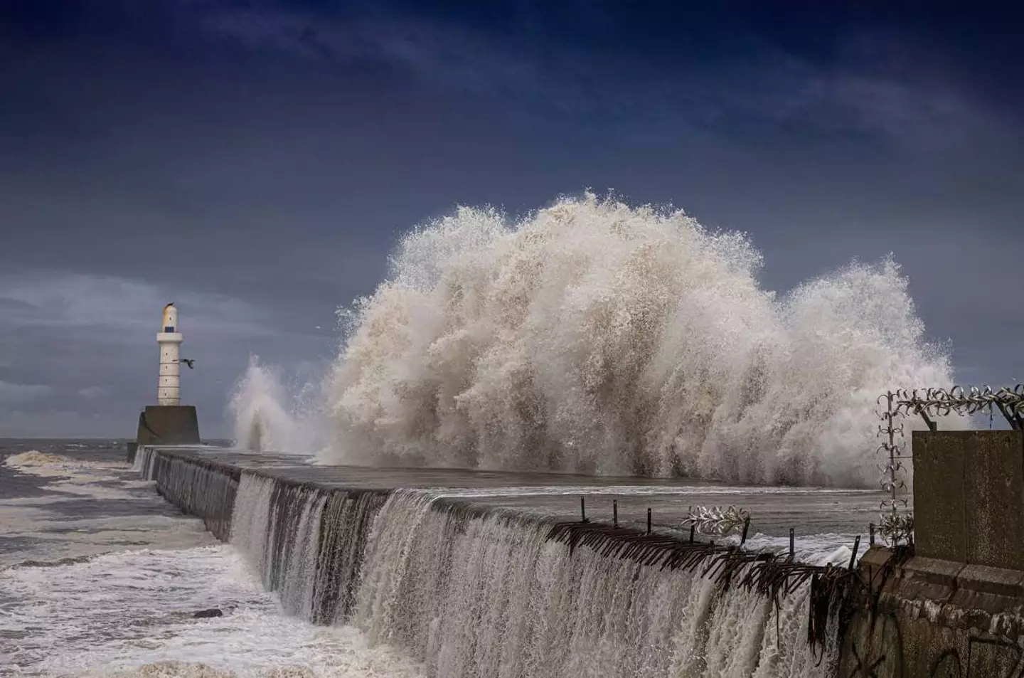 Lighthouse hit by strong waves (Alamy)