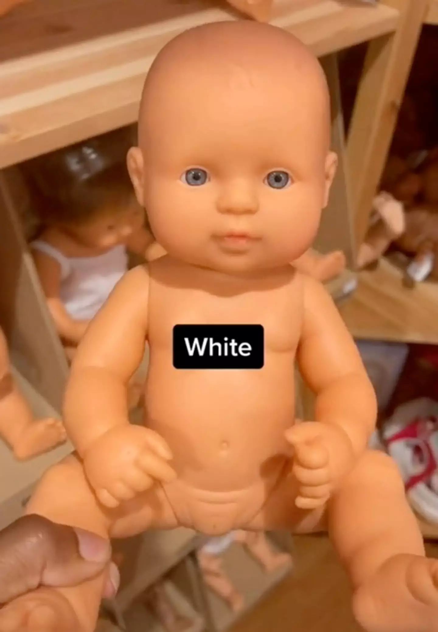The black doll's features are very different to those of the white doll.