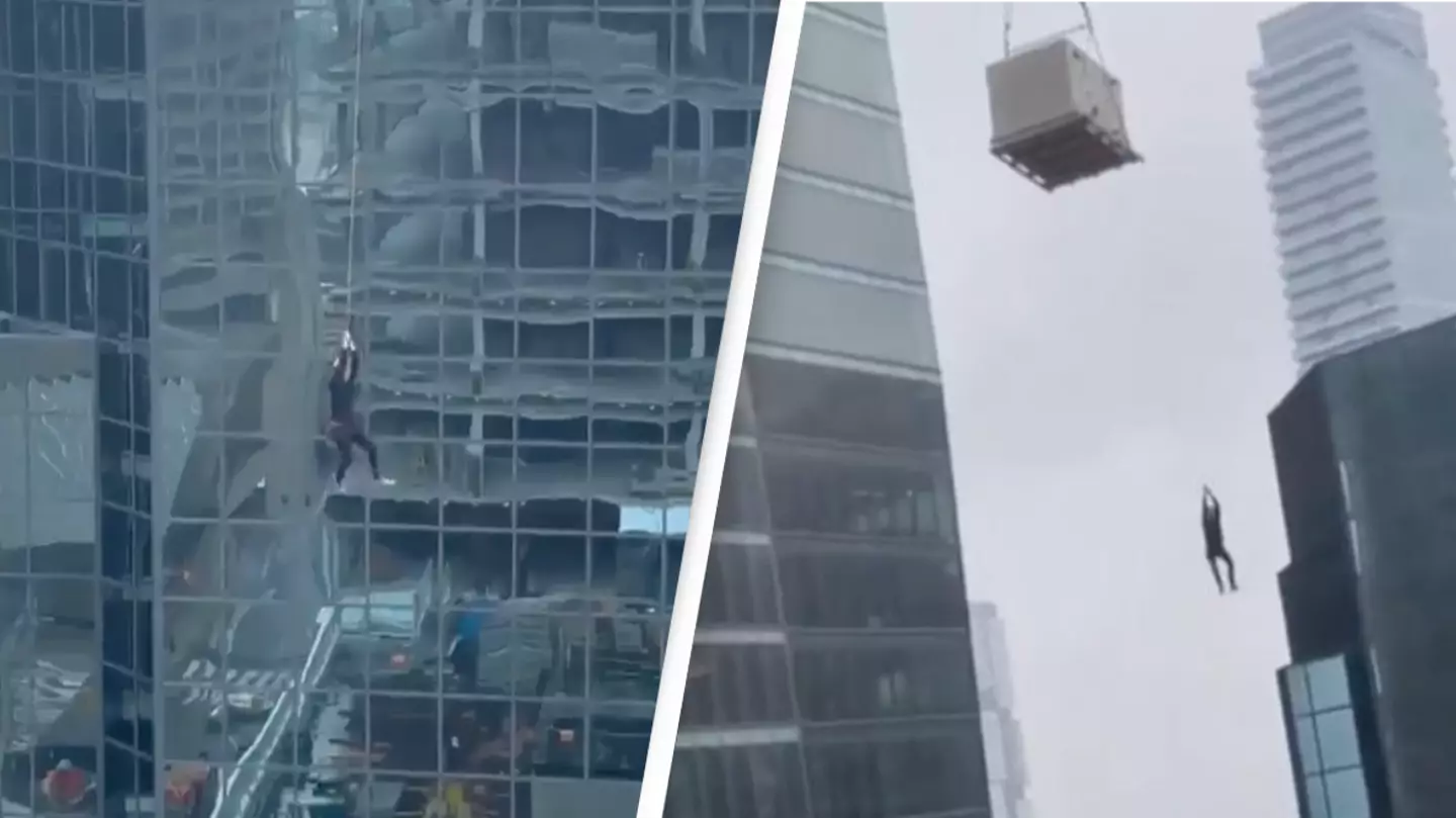 Panic As Construction Worker Spotted Dangling From Crane