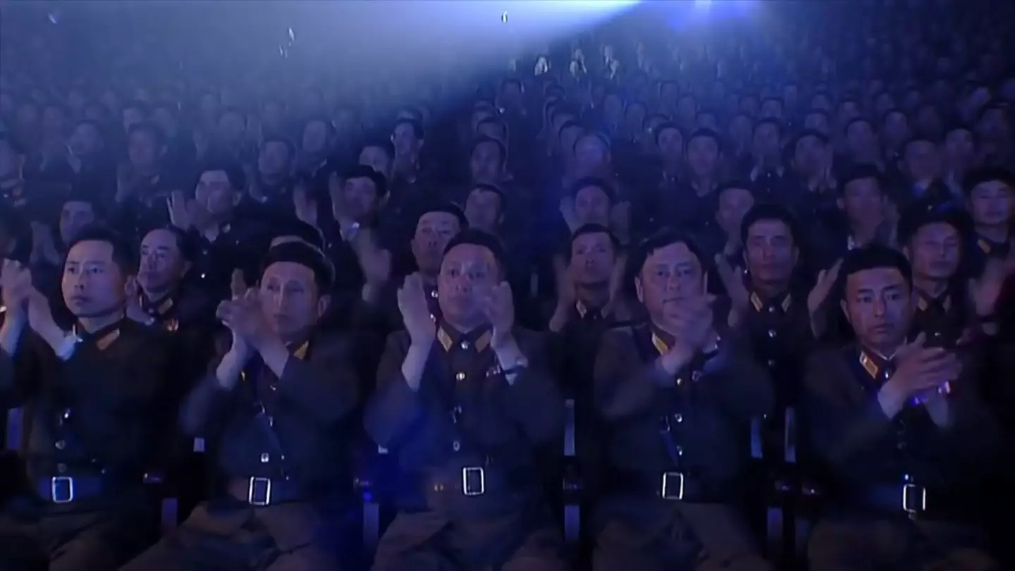 Nothing says 'absolute banger' like a bunch of unsmiling men sat down and applauding like robots.