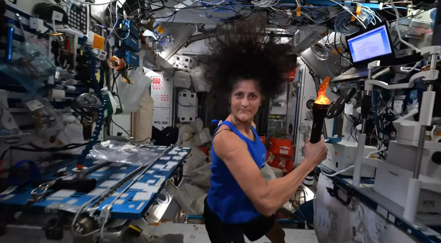 Williams holds the 'Olympic torch' onboard the ISS. (NASA)