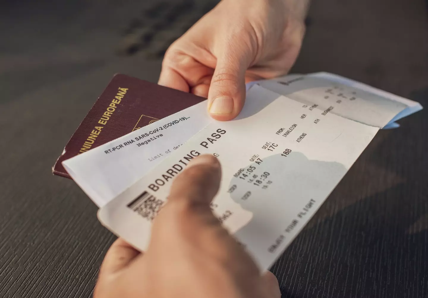 A passenger handing over their boarding pass & passport (Getty Images)