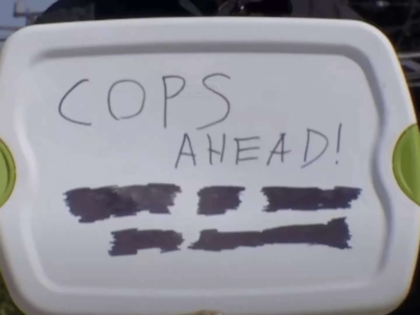 The man received a fine for holding up the sign (KOMO News)