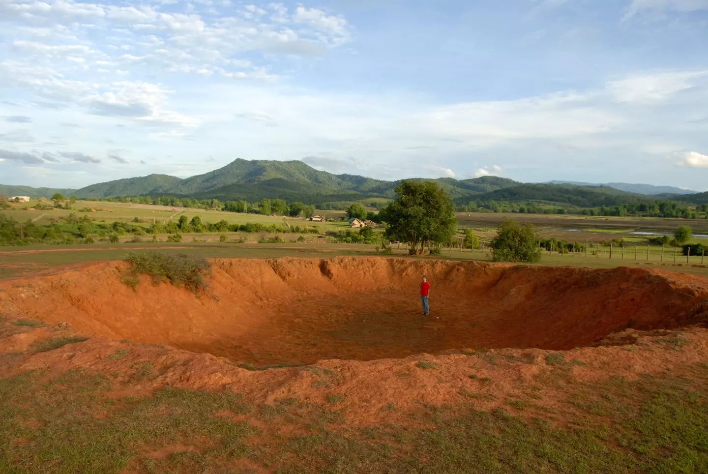 Large bomb crater from the Vietnam War in Ban Khai, Laos.