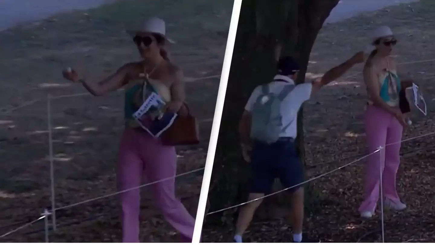 Hilarious moment oblivious spectator picks up player's golf ball during tournament