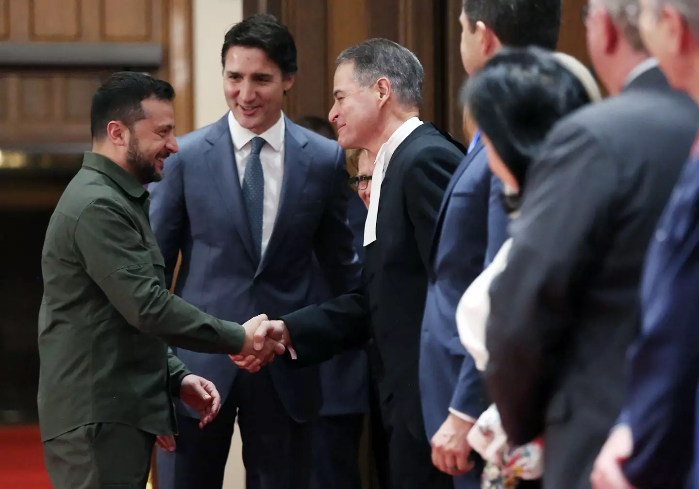 Ukrainian President Volodymyr Zelensky with Canadian Prime Minister Justin Trudeau shaking hands with House of Commons Speaker Anthony Rota.