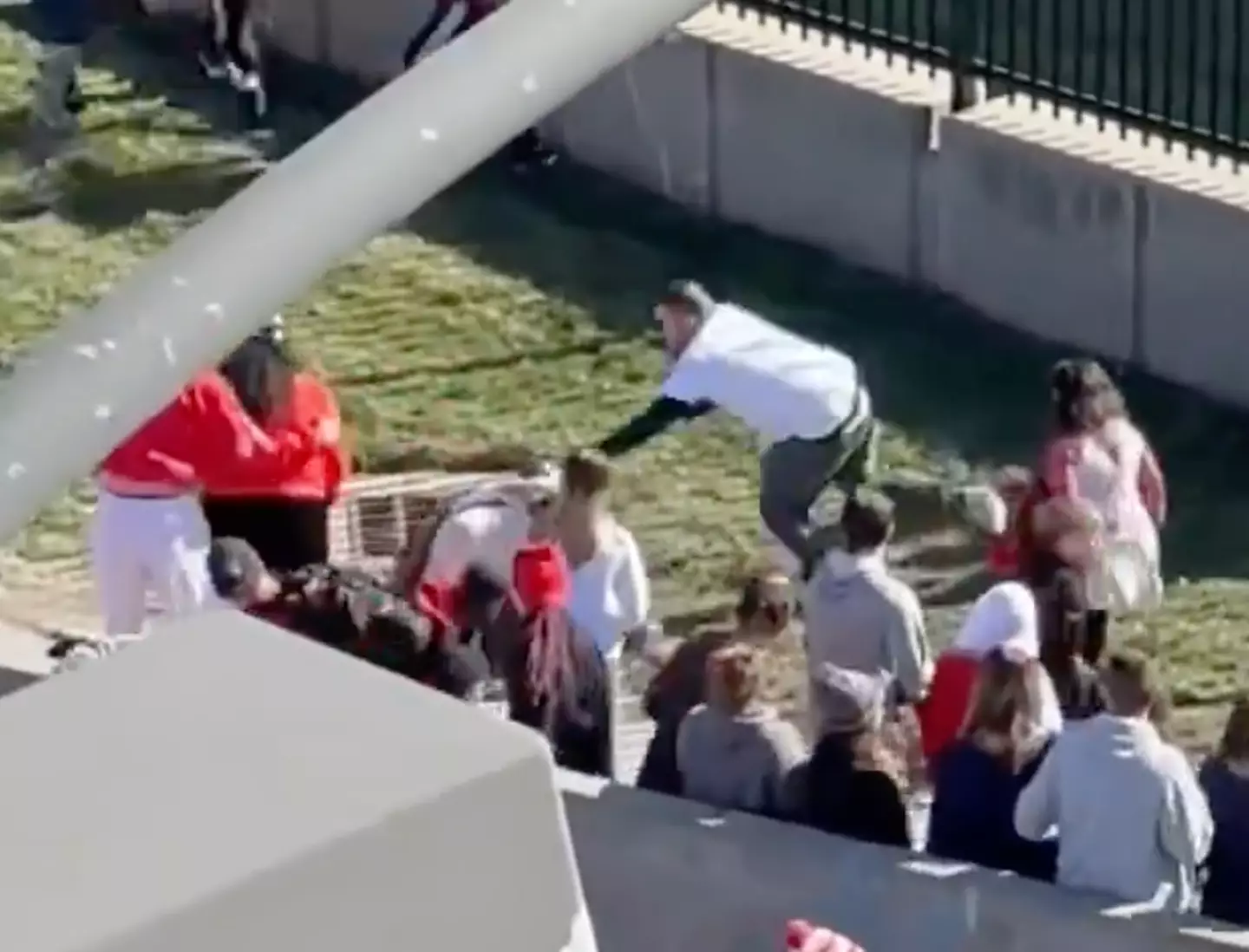 The fans can be seen holding the suspect to the ground.