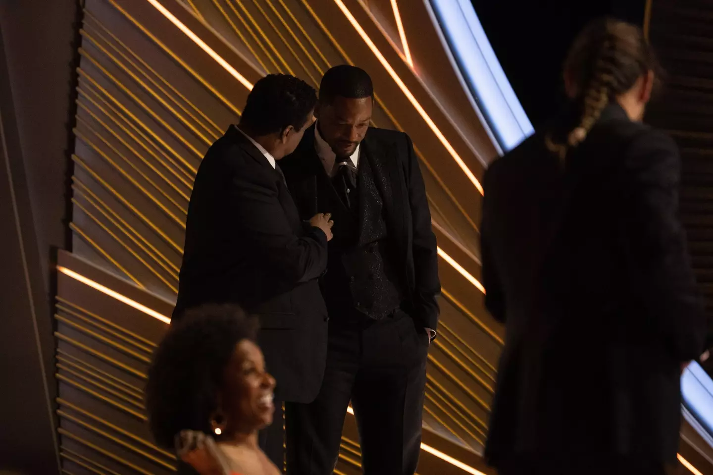 Will Smith talking to Denzel Washington at the Oscars.