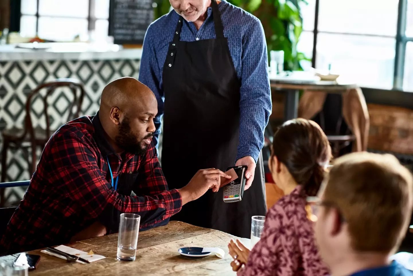 How much to tip often causes tension at the end of a meal.