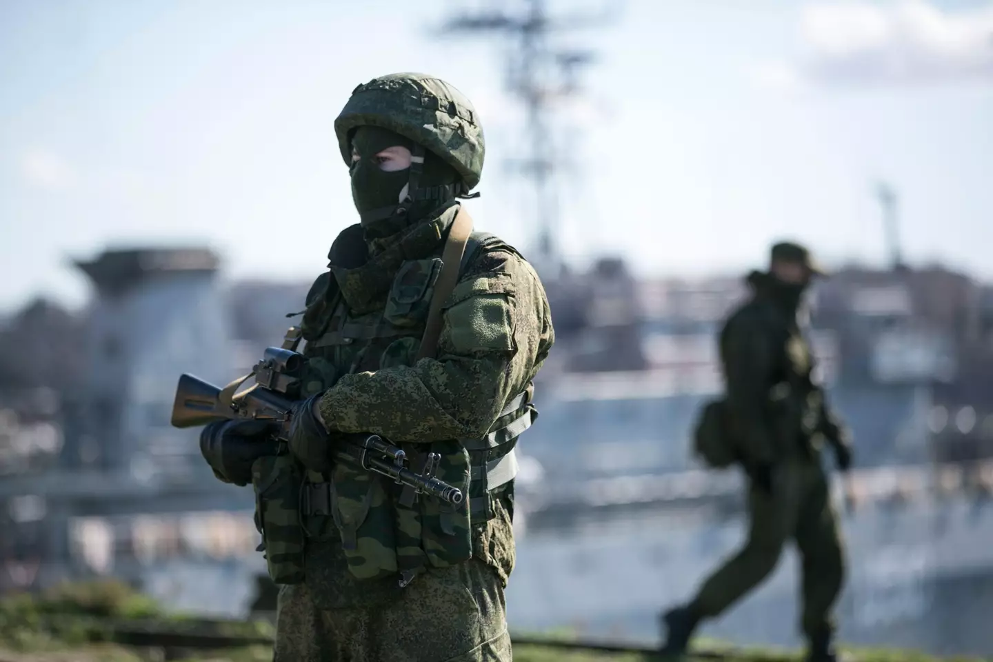 Russian Soldiers stand guard near Ukrainian navy command ship.