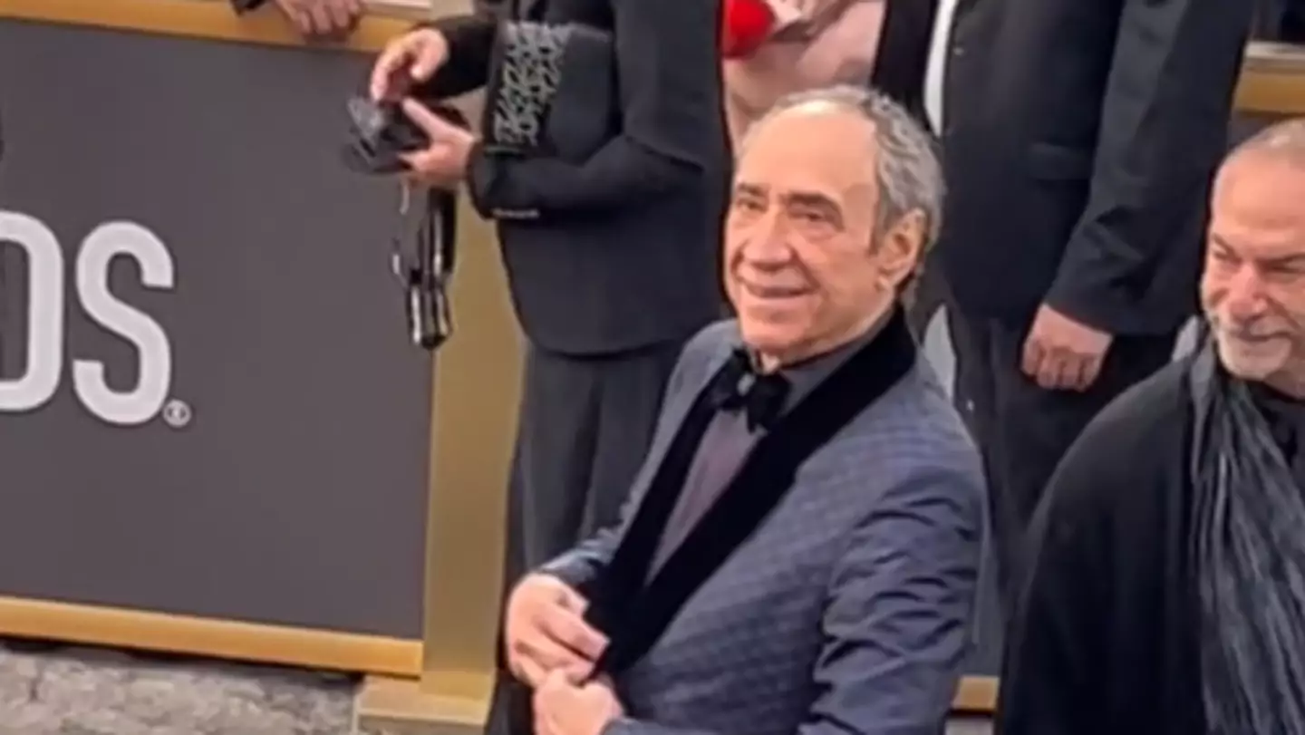 F Murray Abraham playfully showed off his outfit.