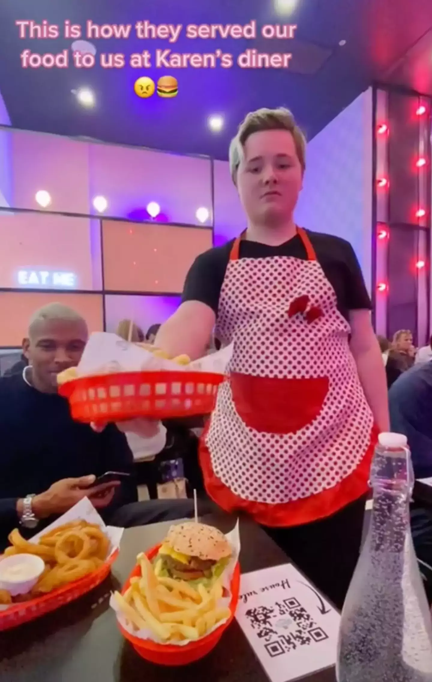 The Karen's Diner waiter delivered three baskets of food to the table with sass.