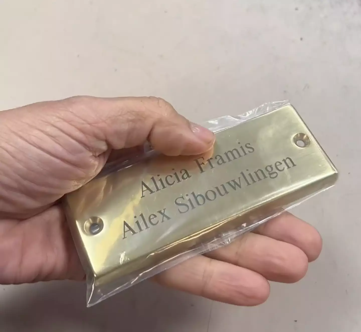 Alicia had a brass plaque made with both of their names engraved.