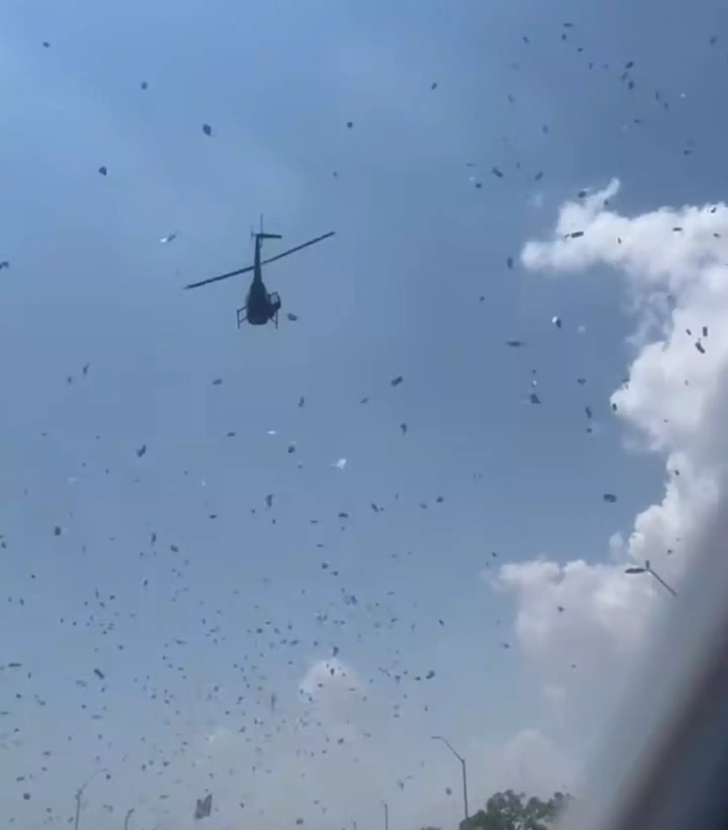 The helicopter hovers as money and petals shower the Detroit streets (Facebook/Crystal Perry)