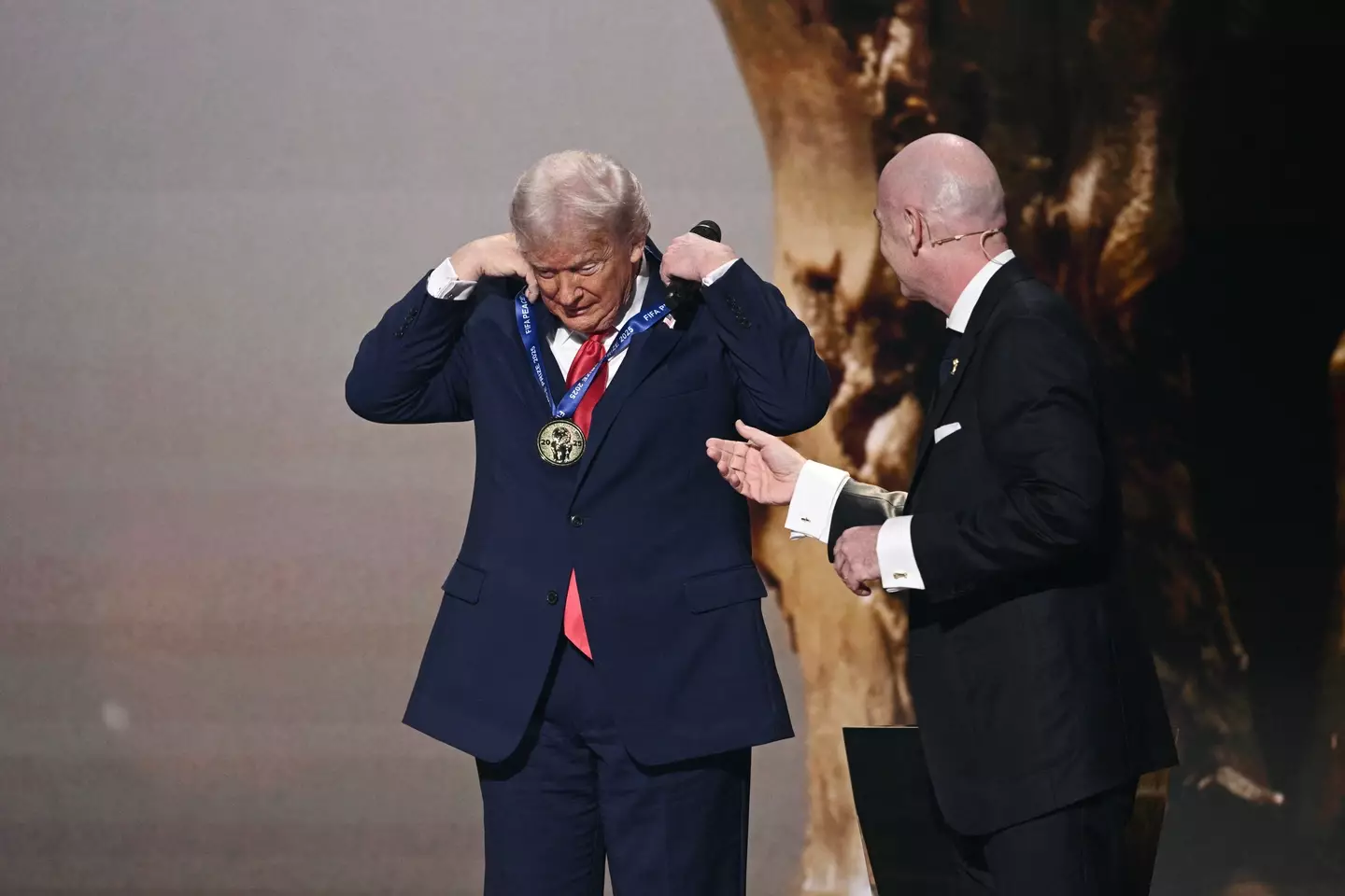 Trump had to put the medal on himself (Photo by Brendan SMIALOWSKI / AFP via Getty Images)
