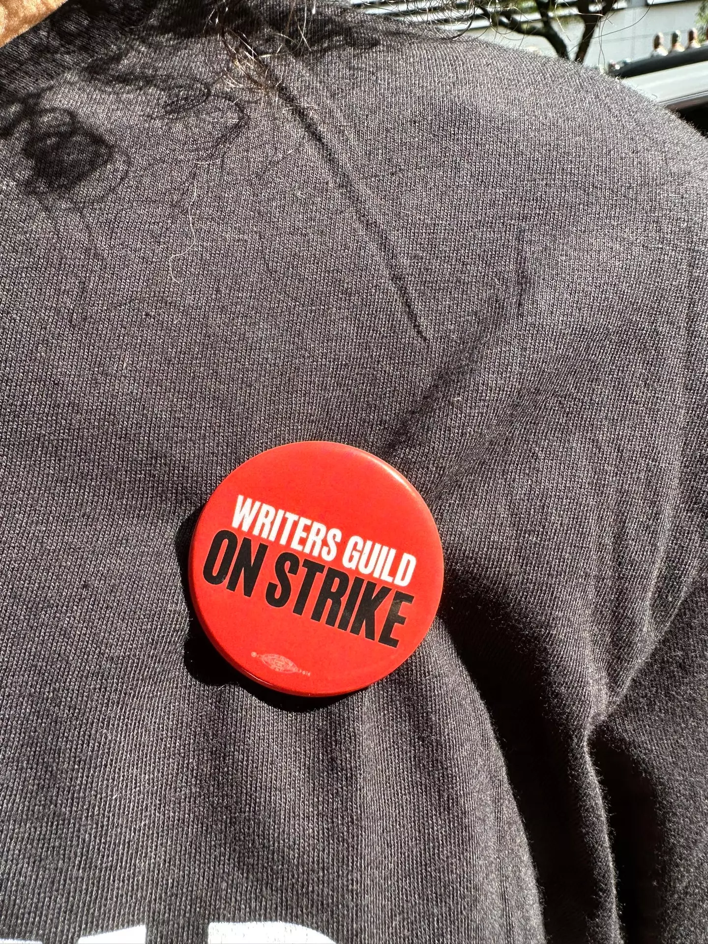 He and a friend picked up WGA badges from strikers.