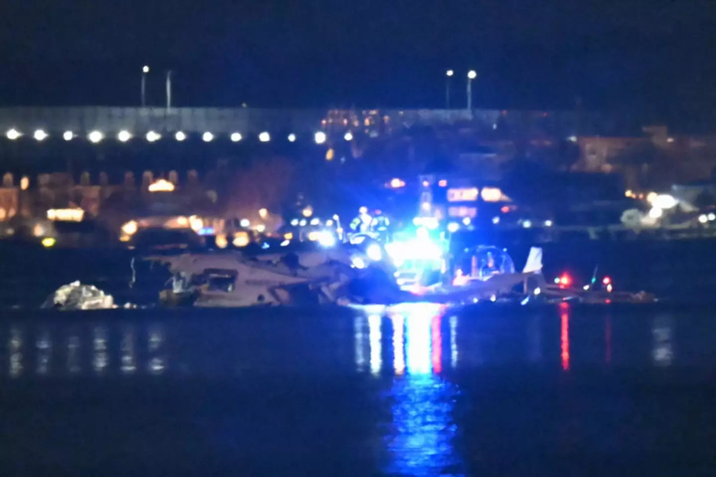 Part of the wreckage is seen as rescue boats search the waters of the Potomac River after a plane on approach to Reagan National Airport crashed into the river (ANDREW CABALLERO-REYNOLDS/AFP via Getty Images)