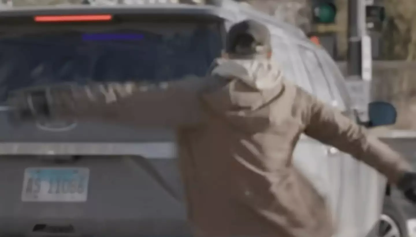 Alex Pretti kicks out a car tail light before he is apprehended by agents (WCCO - CBS Minnesota)