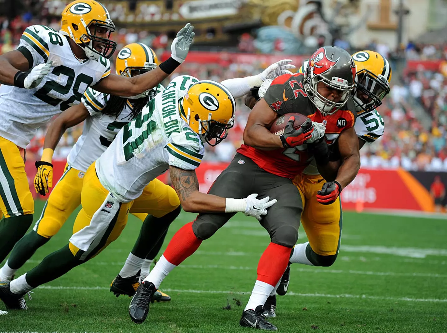Martin seen in the red and black of the Tampa Bay Buccaneers being tackled by the Green Bay Packers (Cliff McBride/Getty Images)