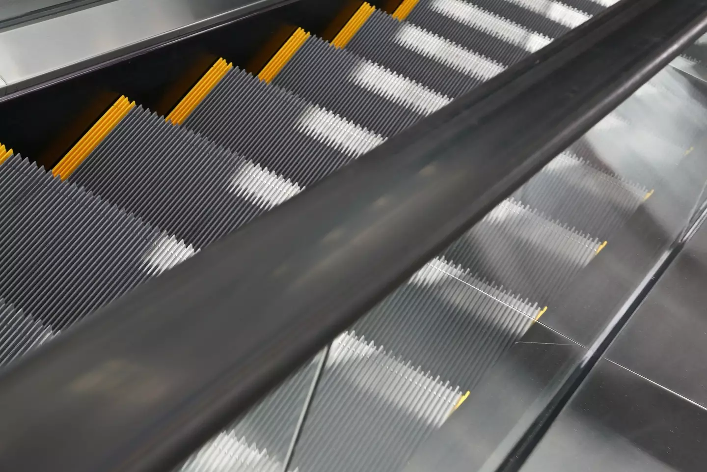 Handrails on an escalator actually move at a faster rate than steps for an important reason (Getty stock)