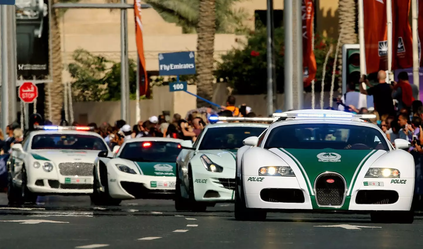 A Dubai police Bugatti leads a convoy of police vehicles, including a Porsche-Panamera, a Lamborghini Aventador and a Bentley (MARWAN NAAMANI/AFP via Getty Images)
