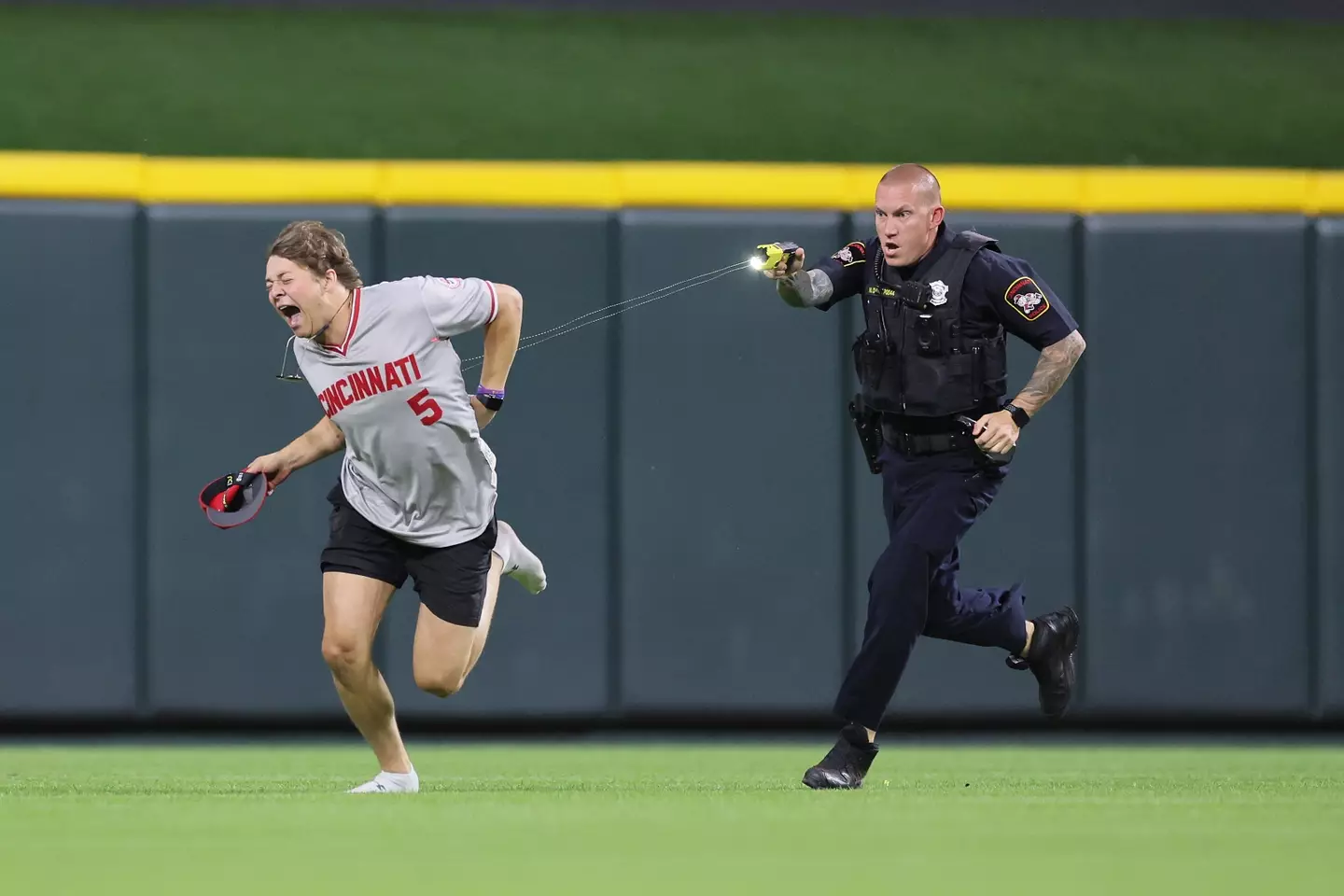 The streaker ran onto the field during the ninth inning of a game between the Cincinnati Reds and Cleveland Guardians. (Andy Lyons/Staff)
