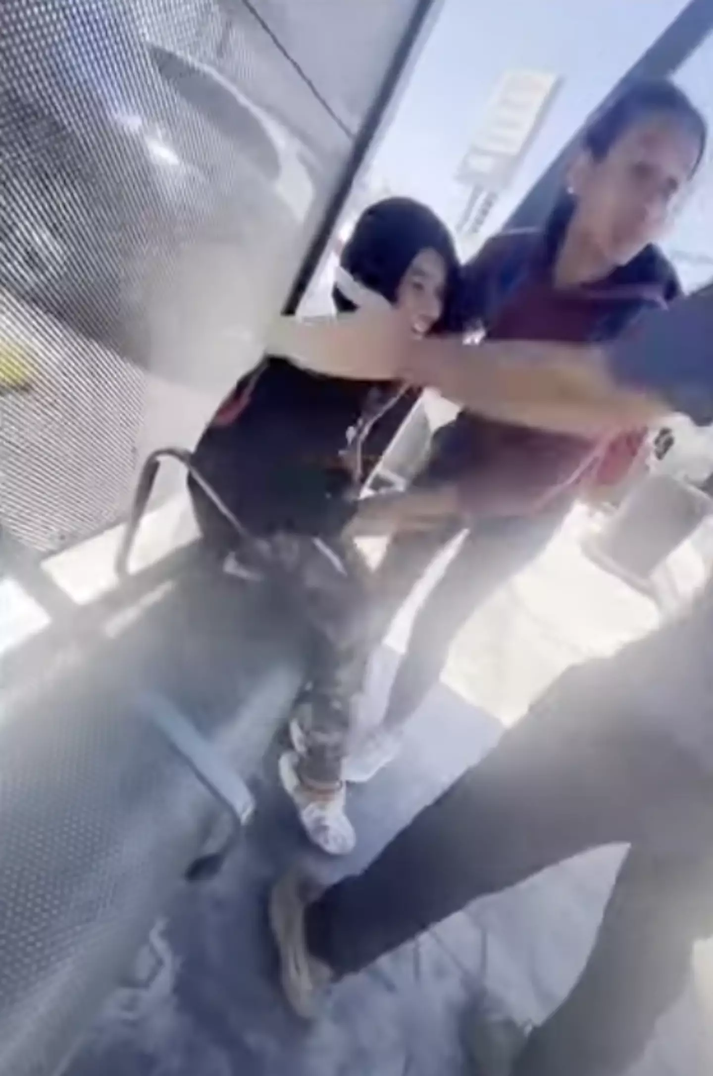 The man is seen getting out of his car and confronting the pair before slapping the child in the face and pointing at the pair of them. (KTLA)