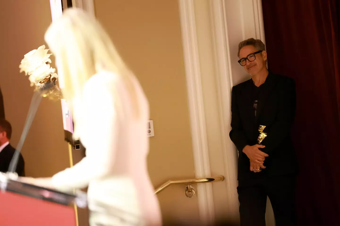 Robert Downey Jr looked pretty happy to be handing his friend the award (Matt Winkelmeyer/The Hollywood Reporter via Getty Images)