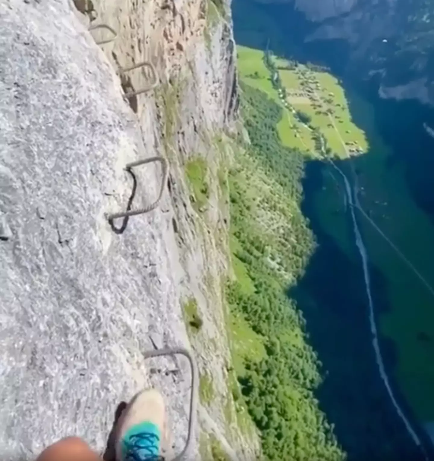 The clip shows hikers stepping on small pieces of rebar steps that have been installed