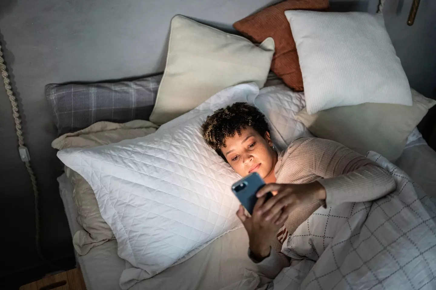 Going on your phone in bed can have devastating affect on your sleep (Getty Stock Image)