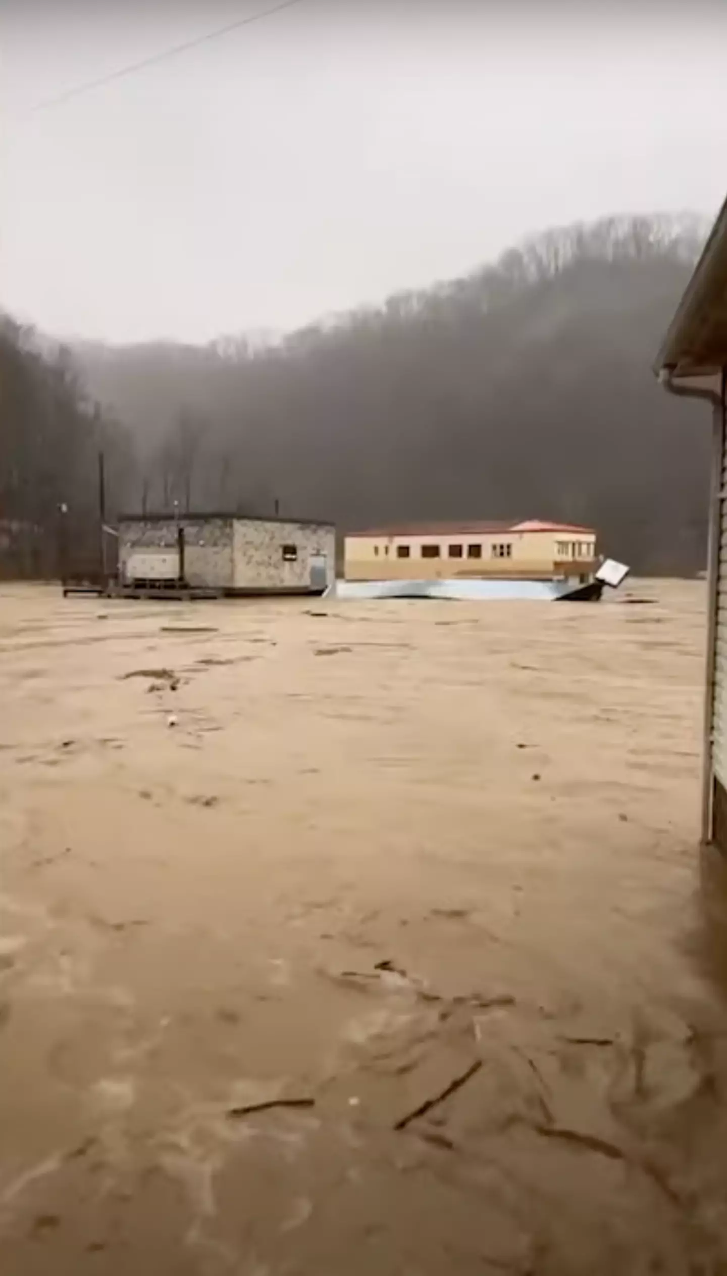 A Virginia resident shows how floods have engulfed her neighborhood (Samantha Broughton/CBS News/YouTube)