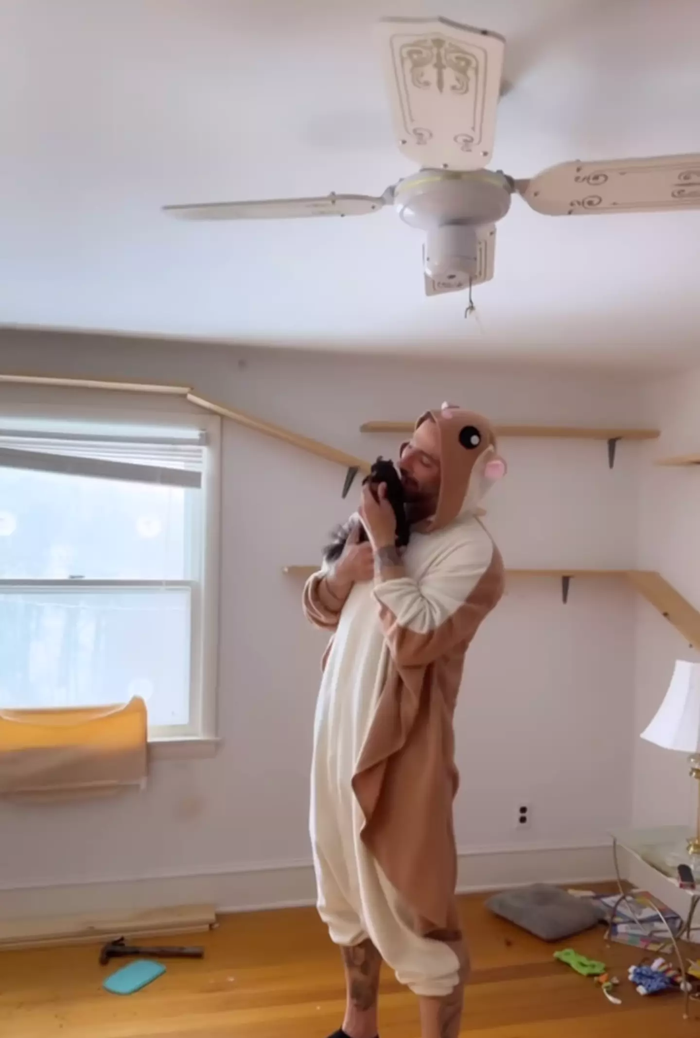 Mark Longo dressed in a squirrel onesie alongside his 'best friend' Peanut (Instagram/@peanut_the_squirrel12)