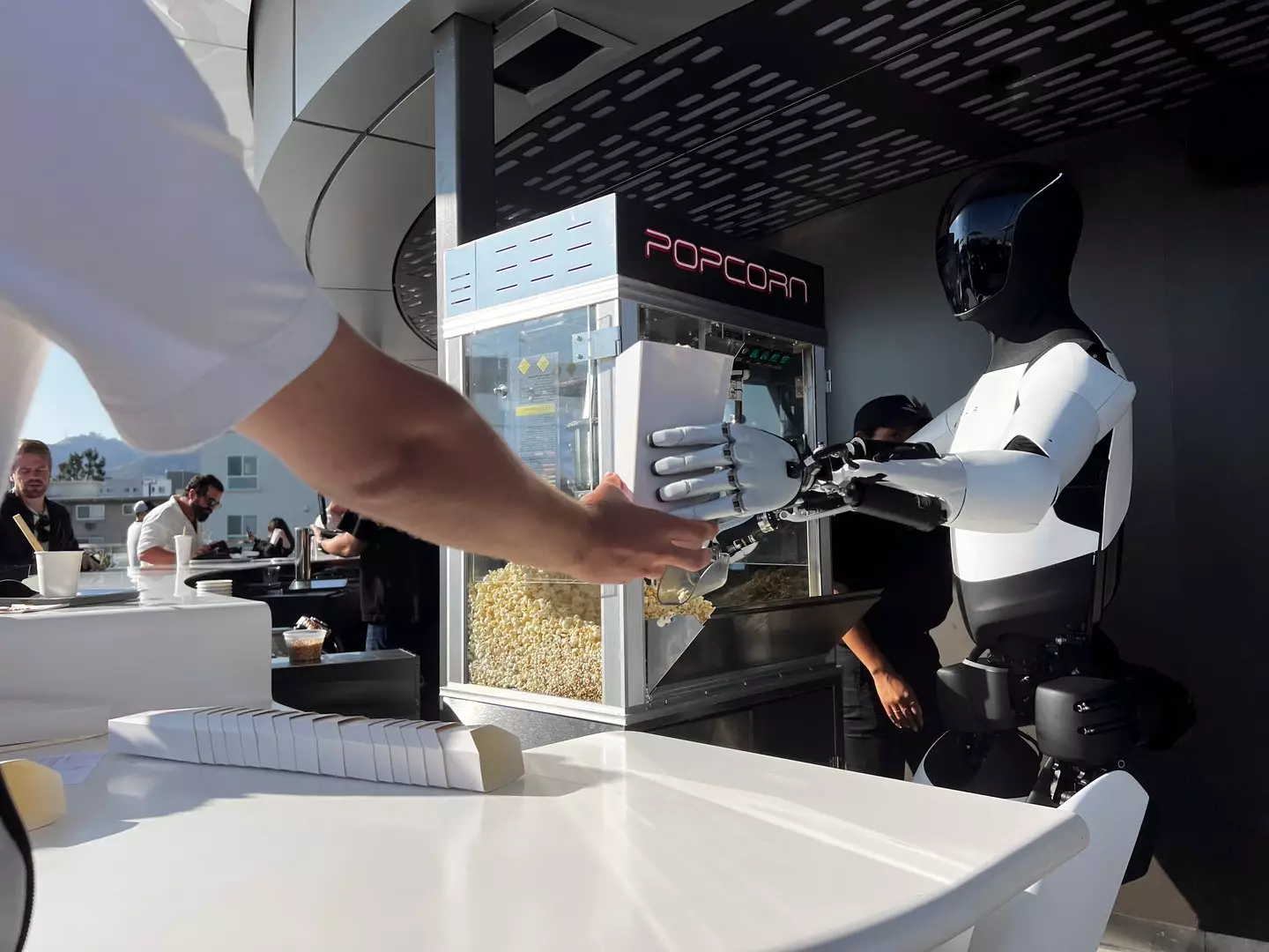 The AI did not say it would be serving popcorn at a Tesla event if it could life for a day (Carlin Stiehl / Los Angeles Times via Getty Images)